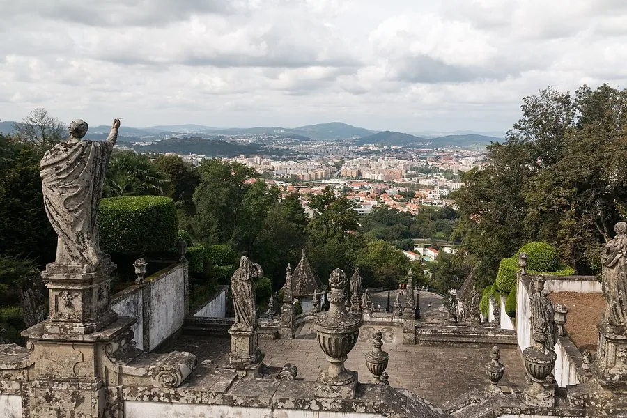 Statues on the terrace with the city of Braga spread out below